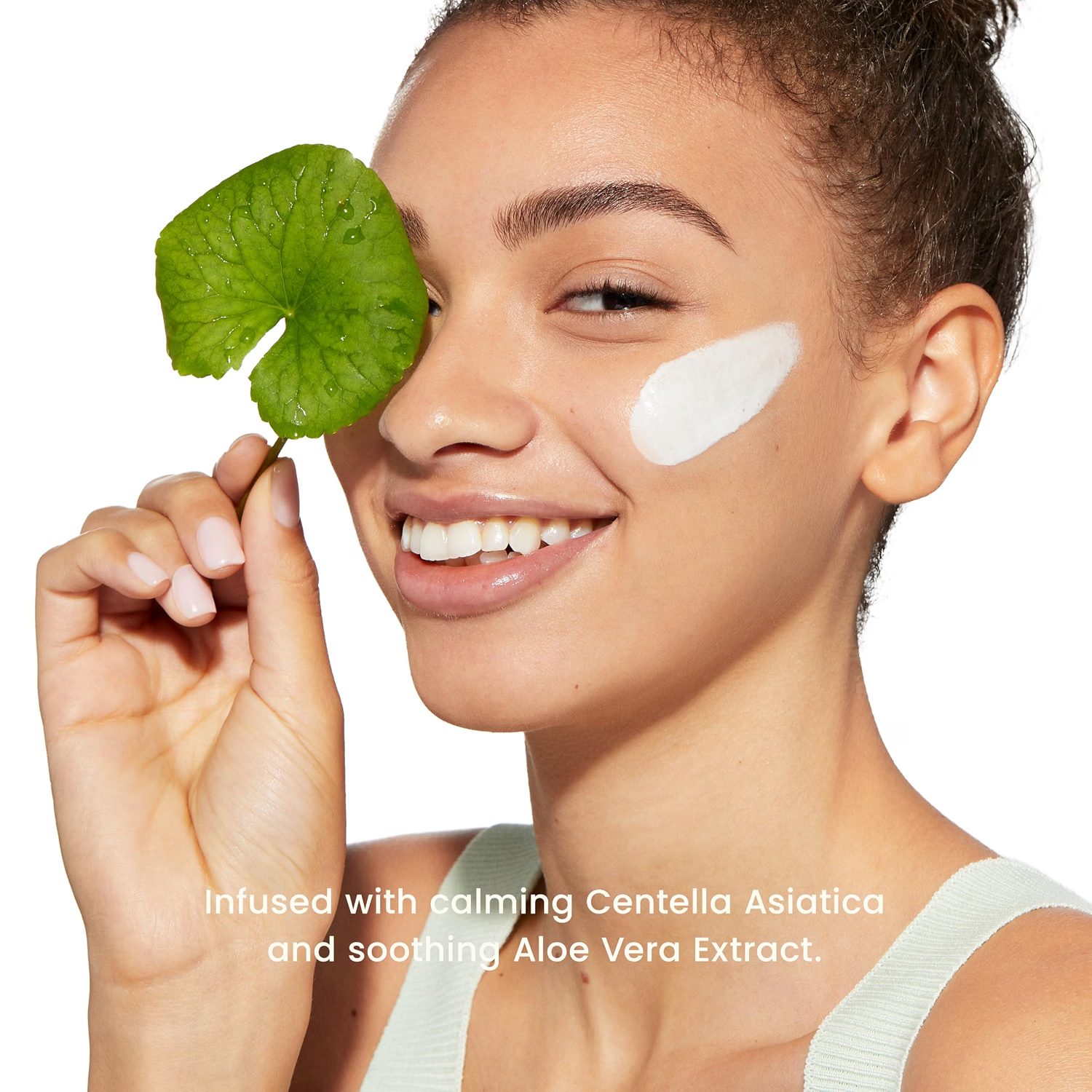 Campaign still — model with centella leaf and primer swatch